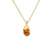 Orange citrine pendant raw nugget on a 18k gold vermeil box chain on a white background