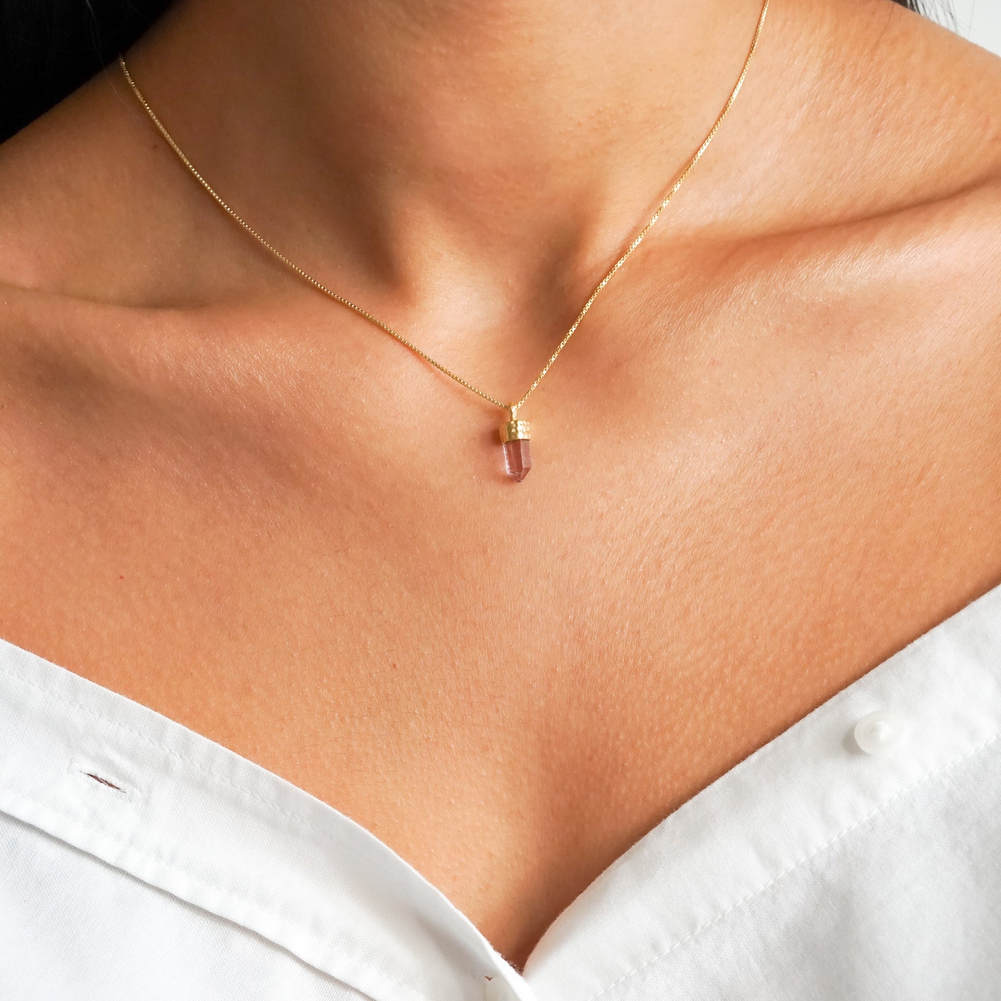 Purple Amethyst point pendant on a 18k gold vermeil box chain on a model neck close up