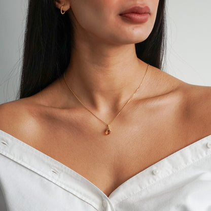 Orange citrine pendant raw nugget on a 18k gold vermeil box chain on model neck