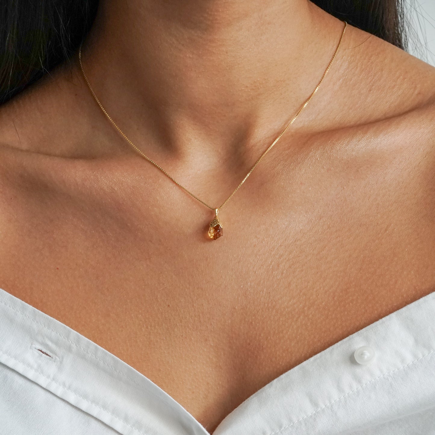 Orange citrine pendant raw nugget on a 18k gold vermeil box chain on model neck