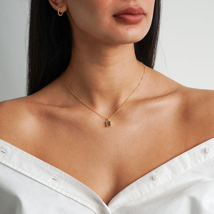 Rectangle flat labradorite pendant on an 18k gold box chain on a model neck