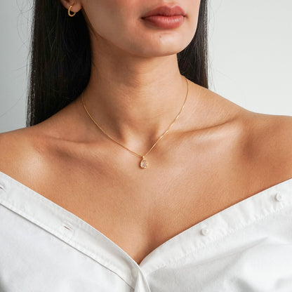 Teardrop shape pink rose quartz pendant with irregular faceting on a 18k gold vermeil box chain on a model neck