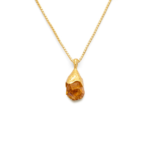 Orange citrine pendant raw nugget on a 18k gold vermeil box chain on a white background
