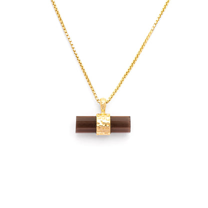 Dark brown smoky quartz pendant in a bar shape with a gold box chain on a white background